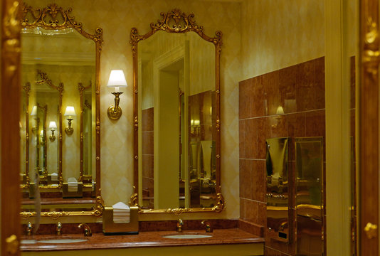 Öffentlicher Waschraum mit goldgerahmten Spiegeln