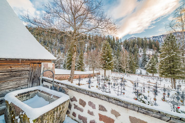 frozen fountain in snowy cemetery