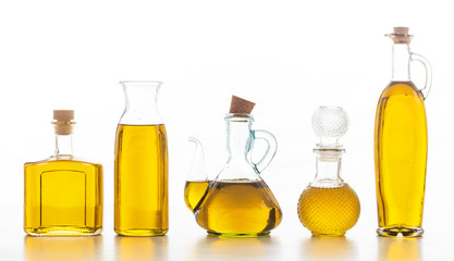 Set of bottles with olive oil on white background
