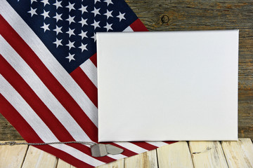 military dog tags on American flag with blank white canvas