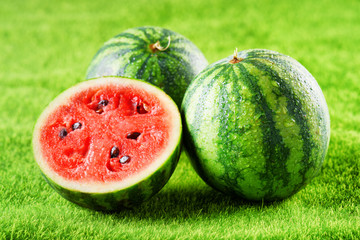 Fresh ripe juicy wet watermelons on green grass. Eco food