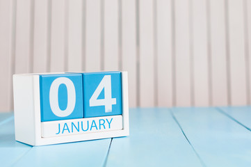 January 4th. Day 4 of month, calendar on wooden workplace background. Winter time. Empty space for...