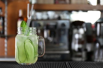 Cocktail in glass jar on bar counter
