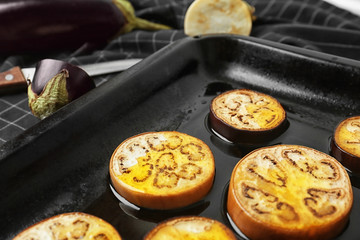 Sliced eggplant on baking tray, closeup
