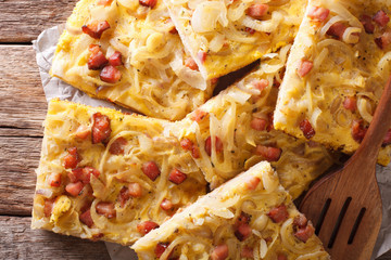 Savory pie with with onions, bacon close-up. Horizontal top view
