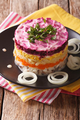 Russian food: Shuba - herring salad with vegetables close-up. vertical
