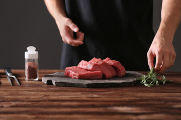 Butcher cooking pork meat on kitchen