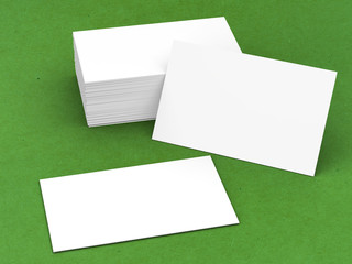 stack of blank name cards on green background