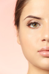 Obraz premium Portrait of beautiful young woman on color background