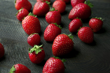 Fresh strawberries on dark wooden background