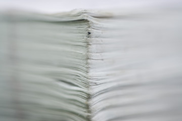 closeup of book spines, edge of many paper