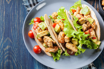Authentic mexican tacos with chicken and salsa with avocado, tomatoes and chillies