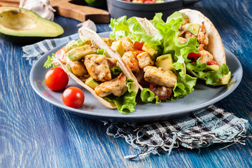 Authentic mexican tacos with chicken and salsa with avocado, tomatoes and chillies