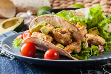 Authentic mexican tacos with chicken and salsa with avocado, tomatoes and chillies