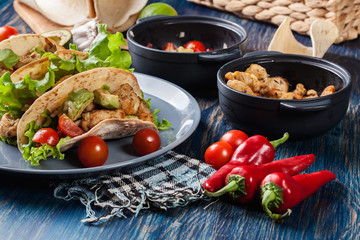 Authentic mexican tacos with chicken and salsa with avocado, tomatoes and chillies