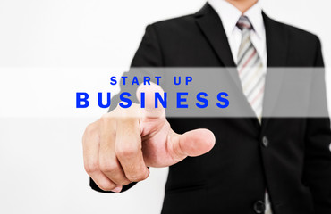 Businessman pressing start up BUSINESS button on screen display, concept of start new business or forward thinking