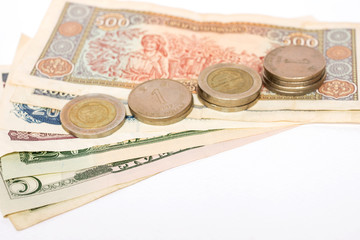 Many coins and banknotes isolated on white background