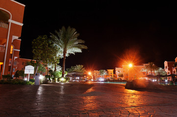 Fototapeta na wymiar Palms of a luxury tropical caribbean resort at night