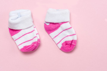 Cotton baby socks for newborn on a colorful pink background. Copy space