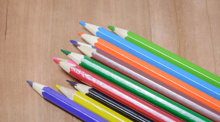 Fototapeta premium Color pencils on wood table