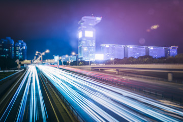 Obraz premium traffic light trails on urban street in city of China.