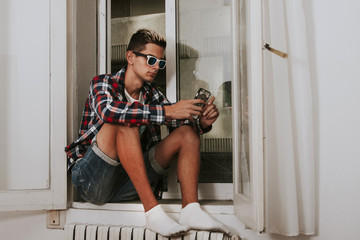 flapper with mobile phone in the home window