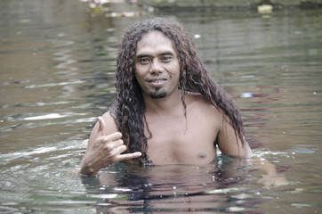 asian man swiming in the lake