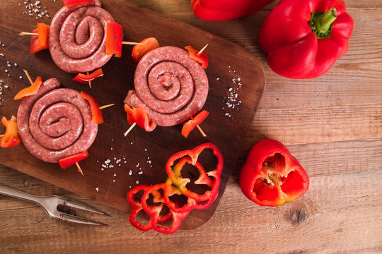 Raw sausage on wooden table. 