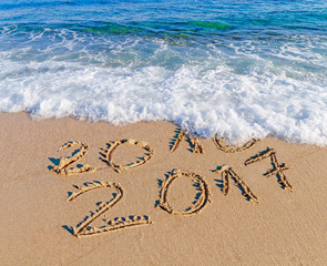 Happy New Year 2017 replace 2016 concept on the sea beach