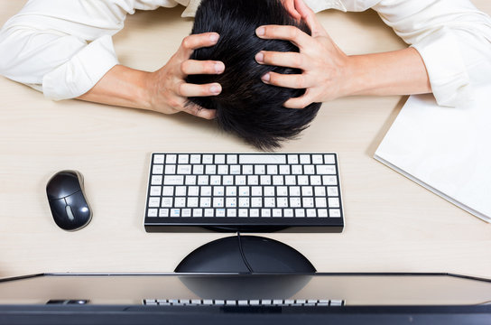 Tired & headache asian businessman or employee work overtime