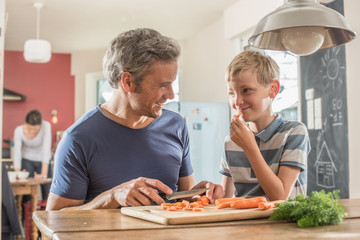  father and son preparing lunch in the kitchen