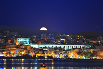Fototapeta premium Full moon rising over the city