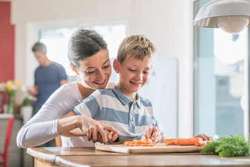 Mother and son preparing lunch in the kitchen © jackfrog