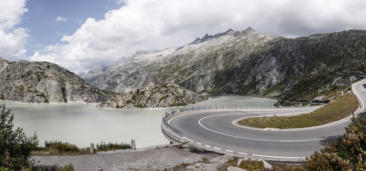 Bend at Grimsel Pass with Grimsel Lake and Hospiz in the Background, in Switzerland
