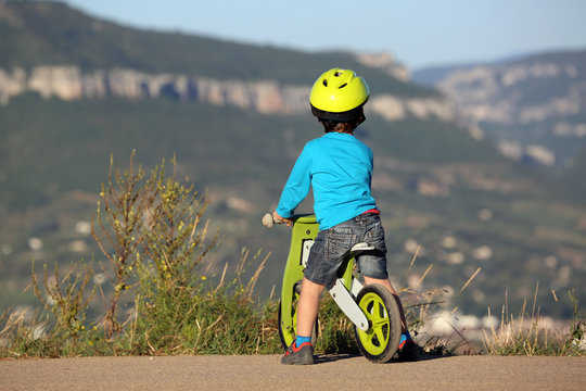 Little Boy Riding Wooden Bike