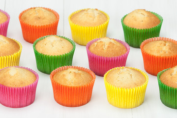 Homemade Colorful Plain Cupcakes On White Table.