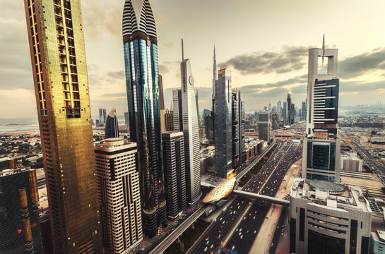 Scenic skyline of a big futuristic city with world tallest skyscrapers. Aerial view over downtown Dubai, UAE. Artistic travel and architectural background.