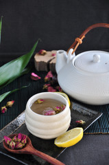 Rose Tea Cup on Tray with Tea Pot on Background