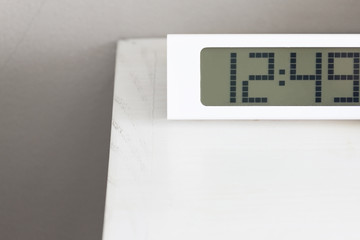 White clock digital on white table