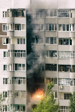 Fire with black smoke in multistory apartment building
