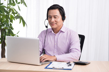 Portrait of handsome asian hotline person consultant wearing hea