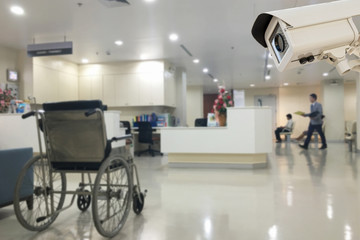 The CCTV security camera operating in office hospital blur backg - obrazy, fototapety, plakaty