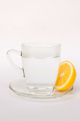 Warm water with lemon isolated on white background