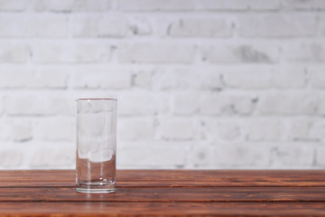 Empty glass on the dark wooden table in cafe