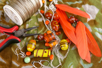 Bead jewelry making as a hobby. Crafting jewelry, wire, feathers and tools.