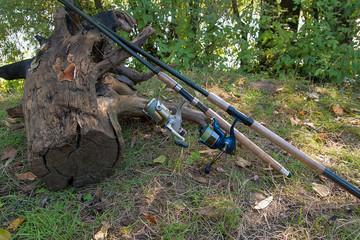 Fishing rods with reels on the natural background.
