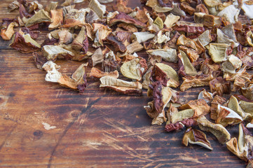 Dried porcini (white mushroom) on old wooden cutting board background