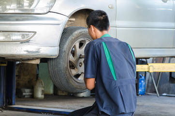 Fototapeta na wymiar Professional car mechanic working in auto repair service