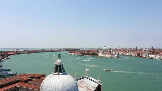 Boats navigating along the Grand Canal in Venice with the San Gorgio Cathedral in the foreground and the San Marco plaza on the right in Italy famous city. Shot as a time lapse video. 