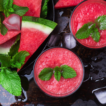 Watermelon slices drink smoothie with mint on grunge table